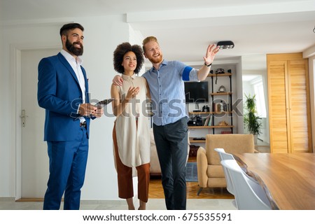 Young couple with real estate agent. Buying a new house.