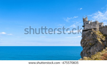 Castle of Swallow's Nest on a rock over the Black Sea in summer, Crimea, Russia. It is a symbol and landmark of Crimea. Beautiful panoramic view of Swallow's Nest for background. Postcard of Crimea.