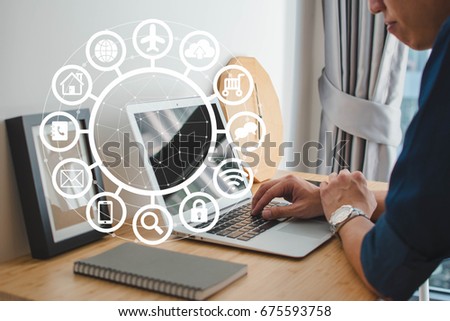 A man using computer  laptop with IOT, internet of things conceptual sign, internet era, internet in every day lifes