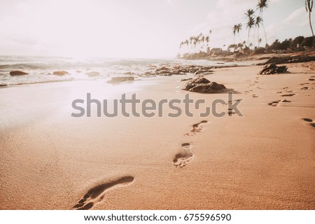 fooprint on sandy ocean beach. vintage toned picture. summer background