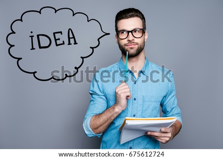 Idea imagination and inspiration concept. Nerdy academic professor genious is thoughtful, in glasses, holding a notebook and thinking about exams