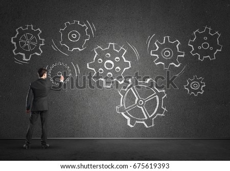 Businessman standing with back and drawing concept of teamwork and cooperation