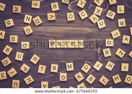 Maths word wood block on table for business concept.