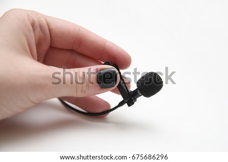 hand with a lavalier microphone