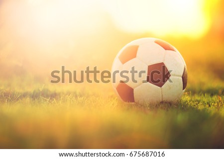 A ball for street soccer football under the sunset ray light. Concept for sport and exercise for kids.Picture with copy space.