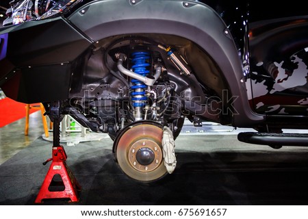 Race car disc brake and blue shock absorber Royalty-Free Stock Photo #675691657