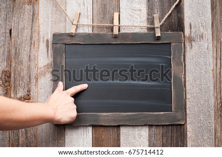 Hand showing on Chalkboard. Human hand pointing on blackboard. 