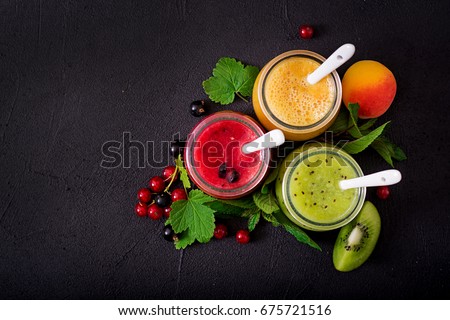 Fresh healthy smoothies from different berries on a dark background. Diet menu. Proper nutrition. Flat lay. Top view. Royalty-Free Stock Photo #675721516
