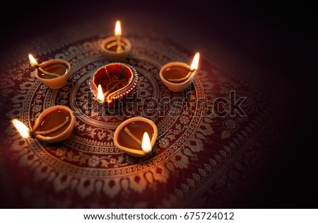 Happy Diwali - Diya lamps lit during diwali celebration Royalty-Free Stock Photo #675724012