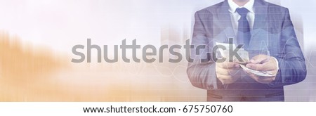Panoramic banner. Double exposure of Businessman with money in hand with cityscape blurred building background. Concept of finance success.