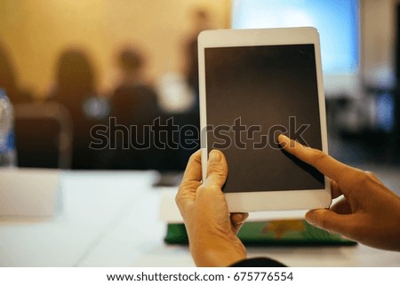 Person touching tablet with finger