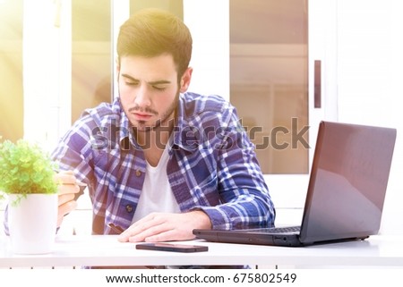 Young man signing paper work in the office