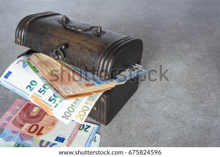 Euro banknotes stuffed in the vintage chest