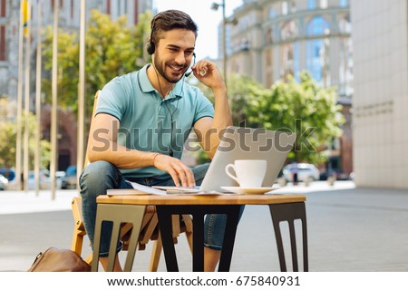 Savvy energetic guy calling someone online Royalty-Free Stock Photo #675840931