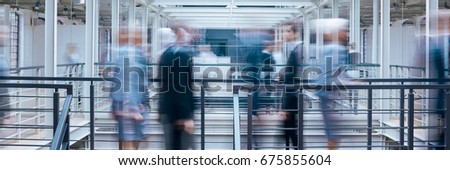 Business people talking in office corridor, industrial interior, panorama