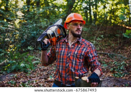 Portrait of a woodcutter with chainsaw