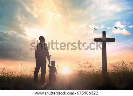 Family worship and holy bible story concept: Silhouette father and son looking for the cross on meadow autumn sunrise background Royalty-Free Stock Photo #675906322