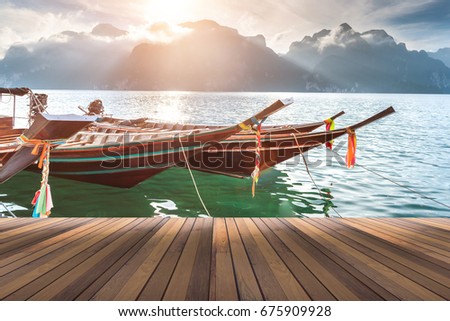 wooden floor and long tail boat anchor at the raft in background space for your text or object in photo