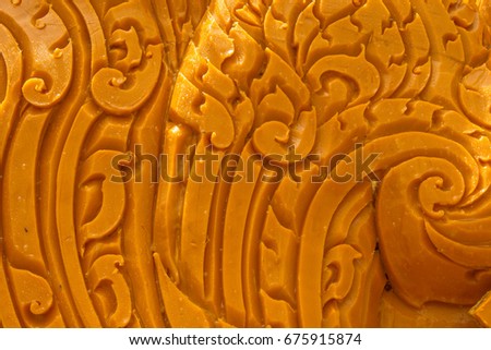 The Art of Yellow Wax Carving The shape and pattern of the delicately beautiful and elaborate value of the technician in the Northeast of Thailand. To use in celebrating Buddhist Lent Festiva
