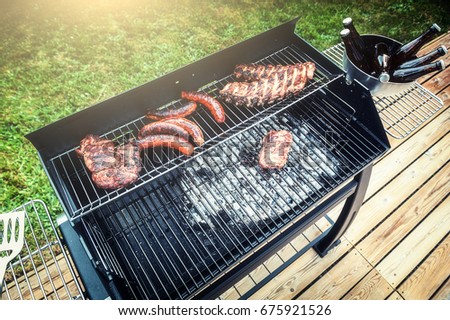 Meat cooking on barbecue grill for summer outdoor party. Food background