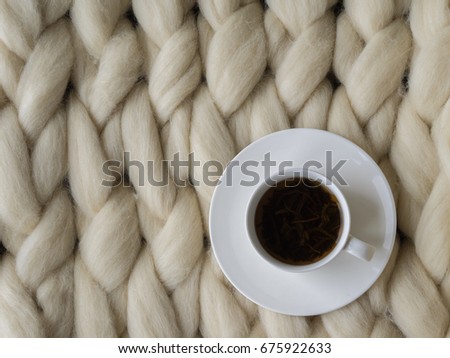 Cozy composition, closeup merino wool blanket, warm and comfortable atmosphere. Knit background