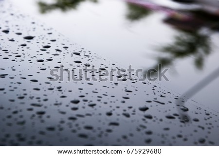 Rain-wet car window contrast with raindrops and cleanly visible road surface / car windows/ Raindrops on car windows Royalty-Free Stock Photo #675929680