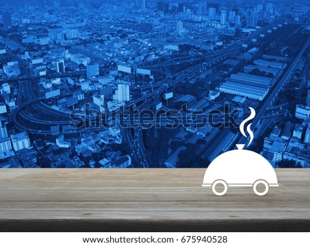 Restaurant cloche flat icon on wooden table over modern office city tower background, Food delivery concept