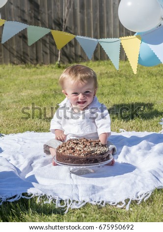 Vertical image of a one year old baby boy chocolate cake smash 