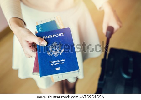 Closeup of girl holding passports and boarding pass Royalty-Free Stock Photo #675951556