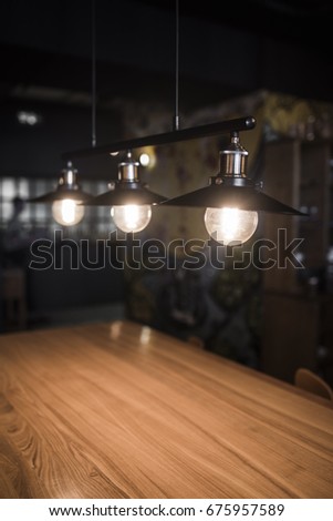 Vintage lamps over a wooden table in a bar