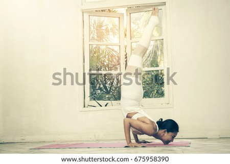 Dramatic Beautiful tattooed woman meditates while practicing yoga. Freedom Beauty fitness woman doing exercises at home Concept of healthy lifestyle.Calmness and relax happiness woman. Toned picture