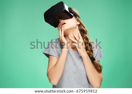 Woman in 3d glasses of virtual reality, game on a green background                               