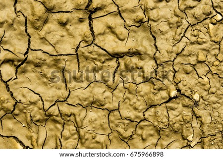 Background texture relief relief structural cracked dry clay soil close-up
