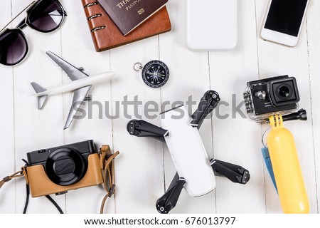 Travel objects and accessories on white wooden, Hi tech gadgets for vacation travel Vlogger and blogger Photography and video footage equipments concept. Royalty-Free Stock Photo #676013797