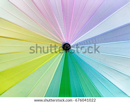 Pastel rainbow coloured umbrella background
