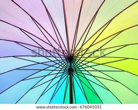 Pastel rainbow coloured umbrella background
