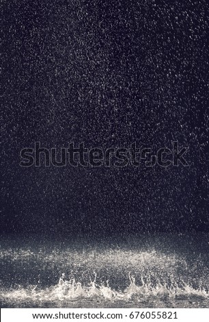 Rain over black background