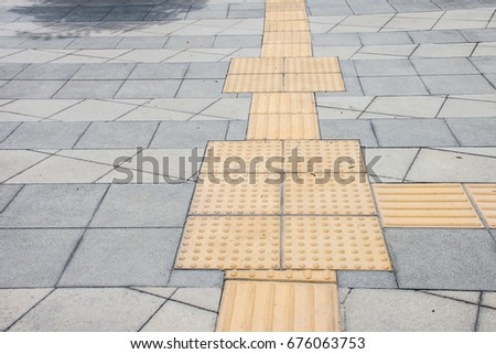 The pathway for people with disabilities in thailand is generally yellow and the surface is uneven