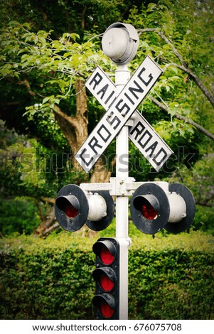 The warning red light at a railway crossing.