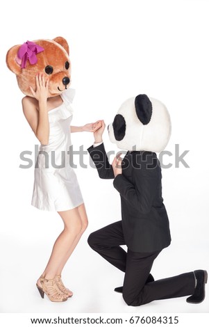 Couple in animal head, panda and bear