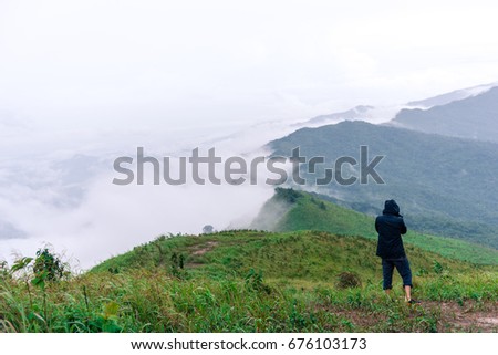 Man photographer taking picture in mountain of Suan Ya Luang, Nan Thailand.