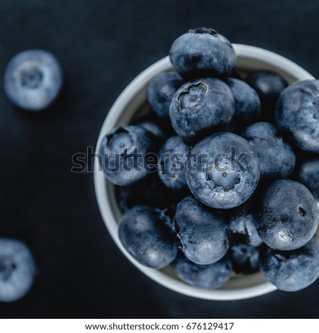 Fresh Blueberry,berries in a white cup on black background, close up Top view