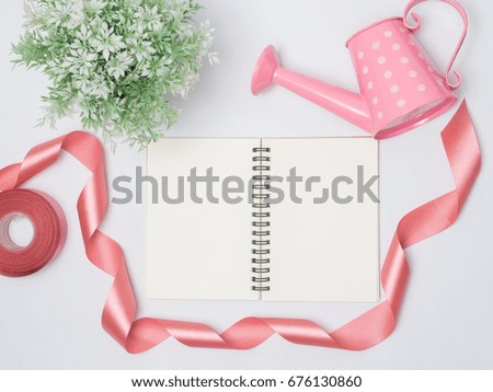 Flat lay, top view office table desk frame. feminine desk workspace with laptop, watch on white background.Love concept top view composition.note for something in love emotion.Watering can pink color.