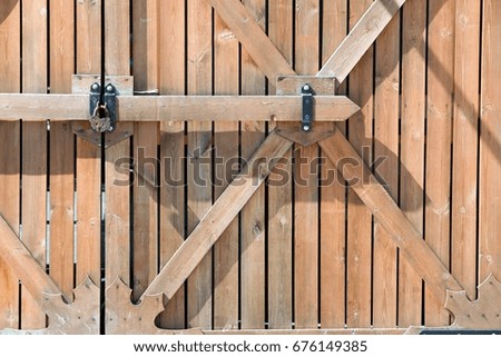 Wooden fence. a barrier, railing, or other upright structure, typically of wood or wire, enclosing an area of ground to mark a boundary, control access, or prevent escape.