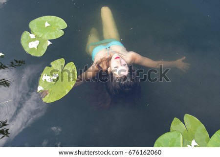 Beautiful blue eyes girl swimming in the water