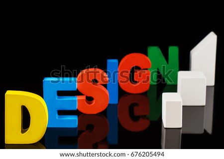 The concept of design word on colorful wooden letters. Design word letters.Letters collected in the word Design
