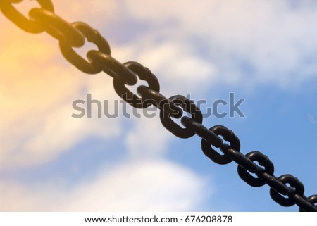 Stretched metal chain outdoors, during the day