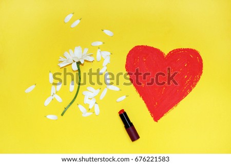 Heart drawn with lipstick on yellow background