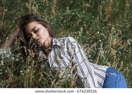 Young pretty woman lying on the grass. Natural happiness, fun and harmony.