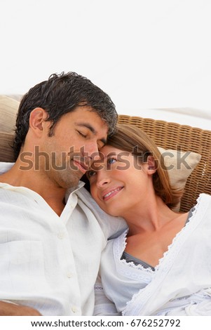 Happy Couple Hugging Tenderly on Chaise Longue